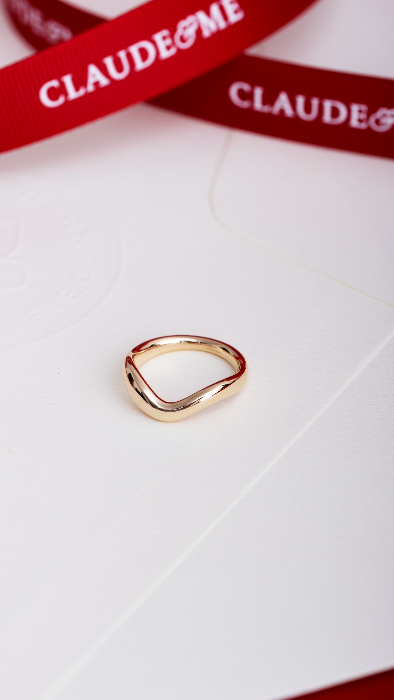 organic wide band on white background with red claude and me ribbon