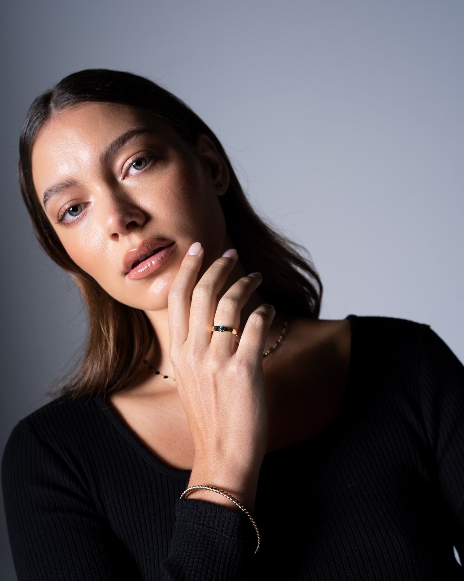 close up image of tension set australian sapphire ring worn by model Ellie Brinkman