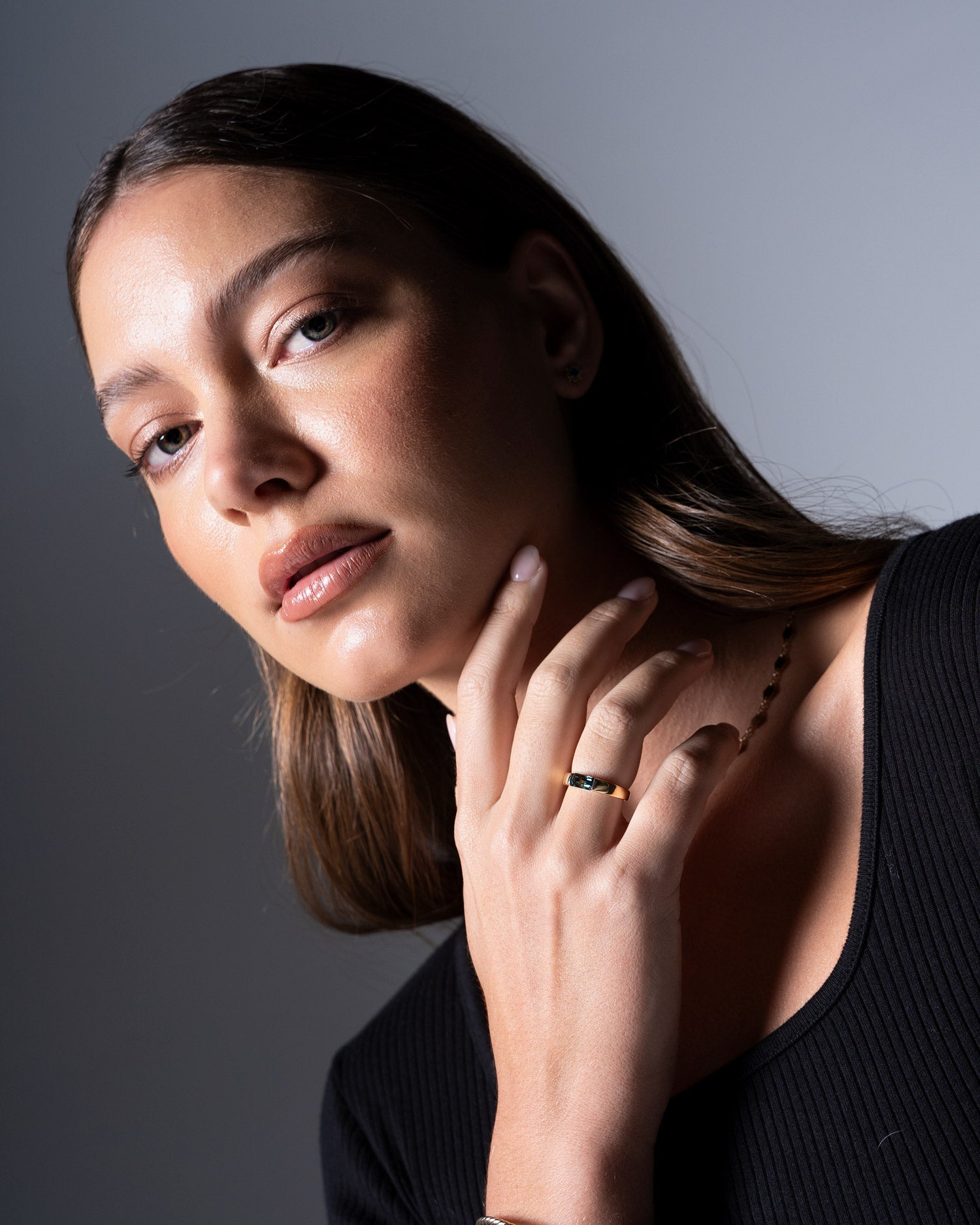 close up image of tension set australian sapphire ring worn by model Ellie Brinkman