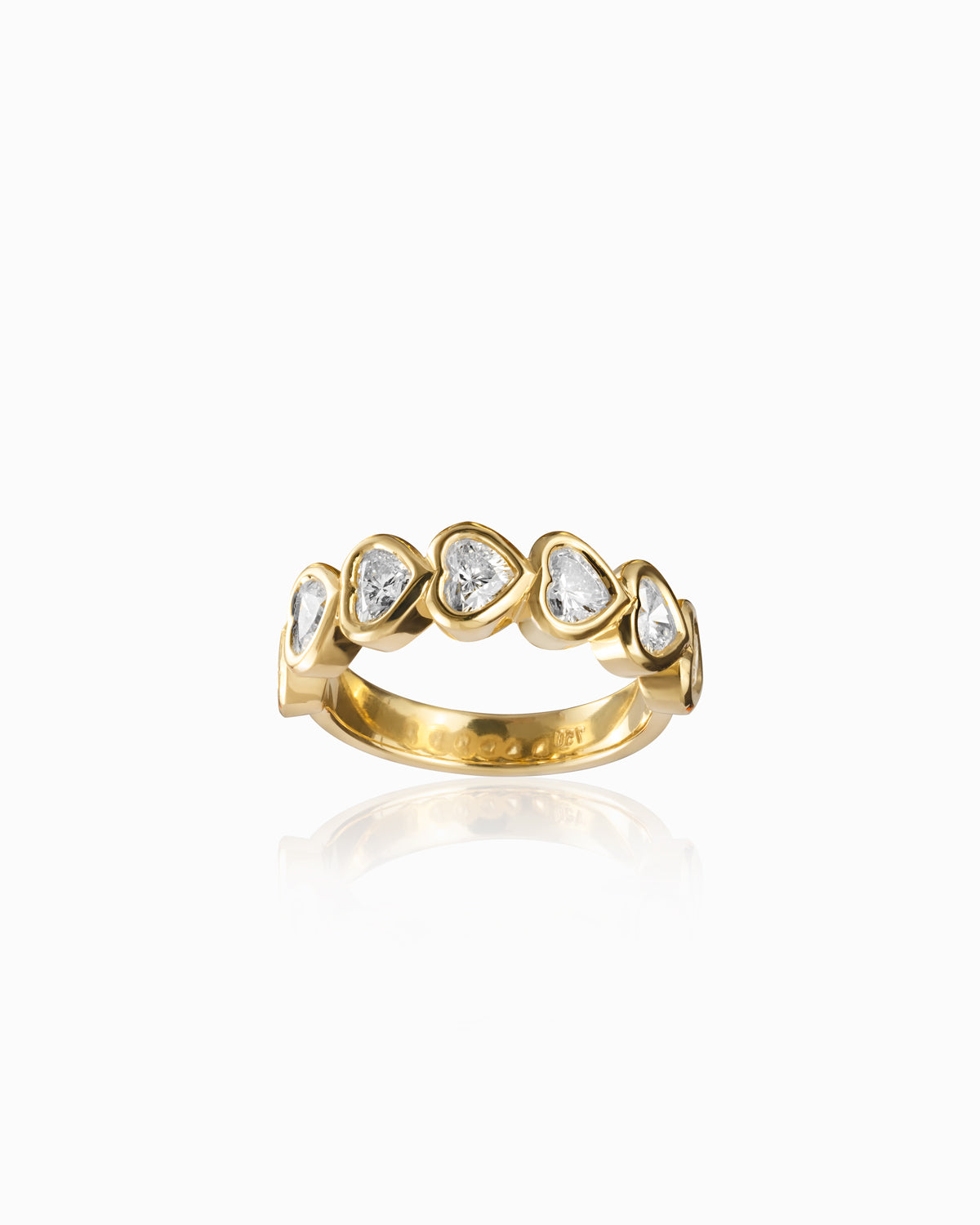Elegant 18k yellow gold band featuring seven heart-shaped diamonds in bezel settings, each diamond with a G color and VS clarity, arranged in a symmetrical pattern to enhance their brilliance and sparkle.