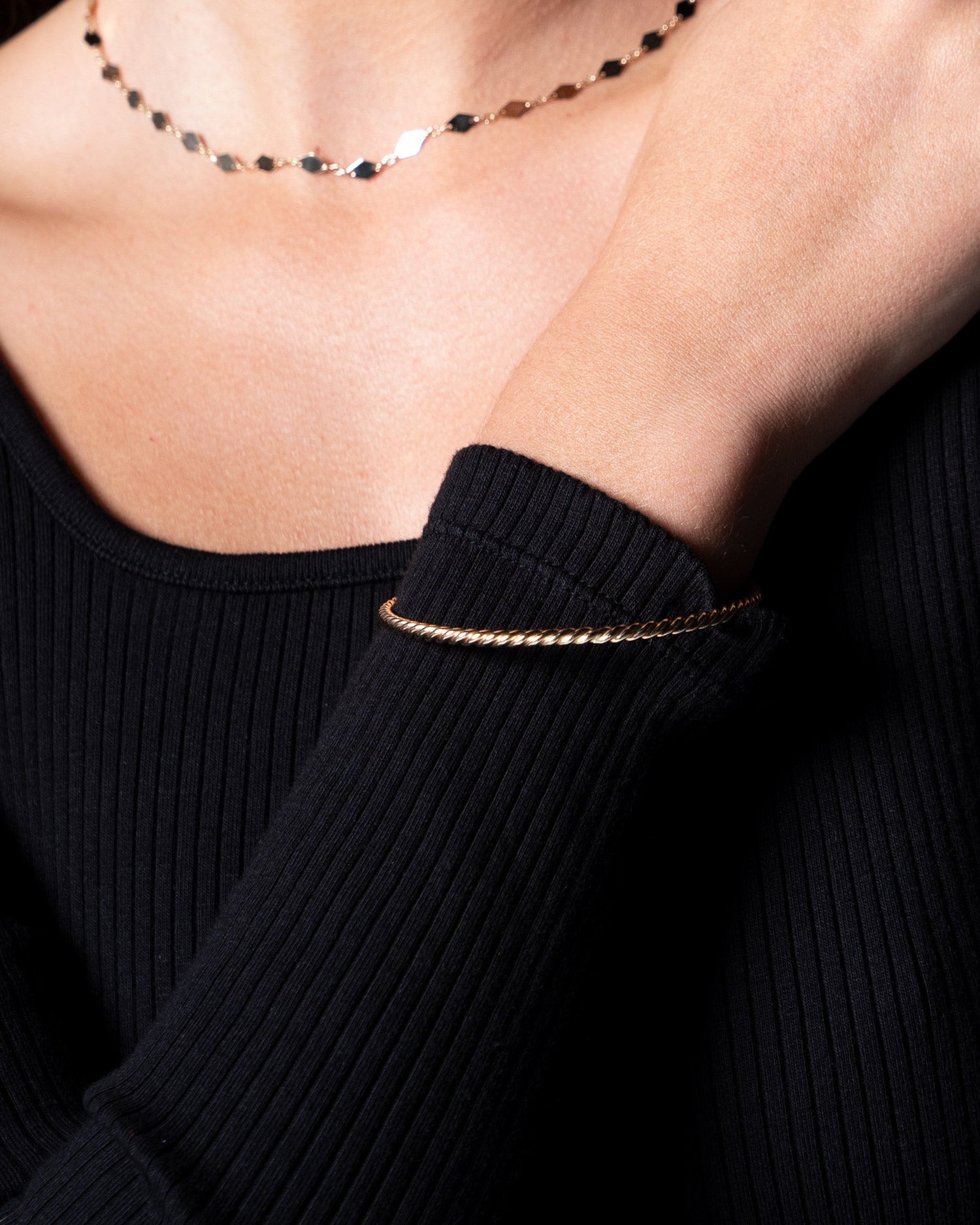 9 karat solid gold twisted bangle on model close up image