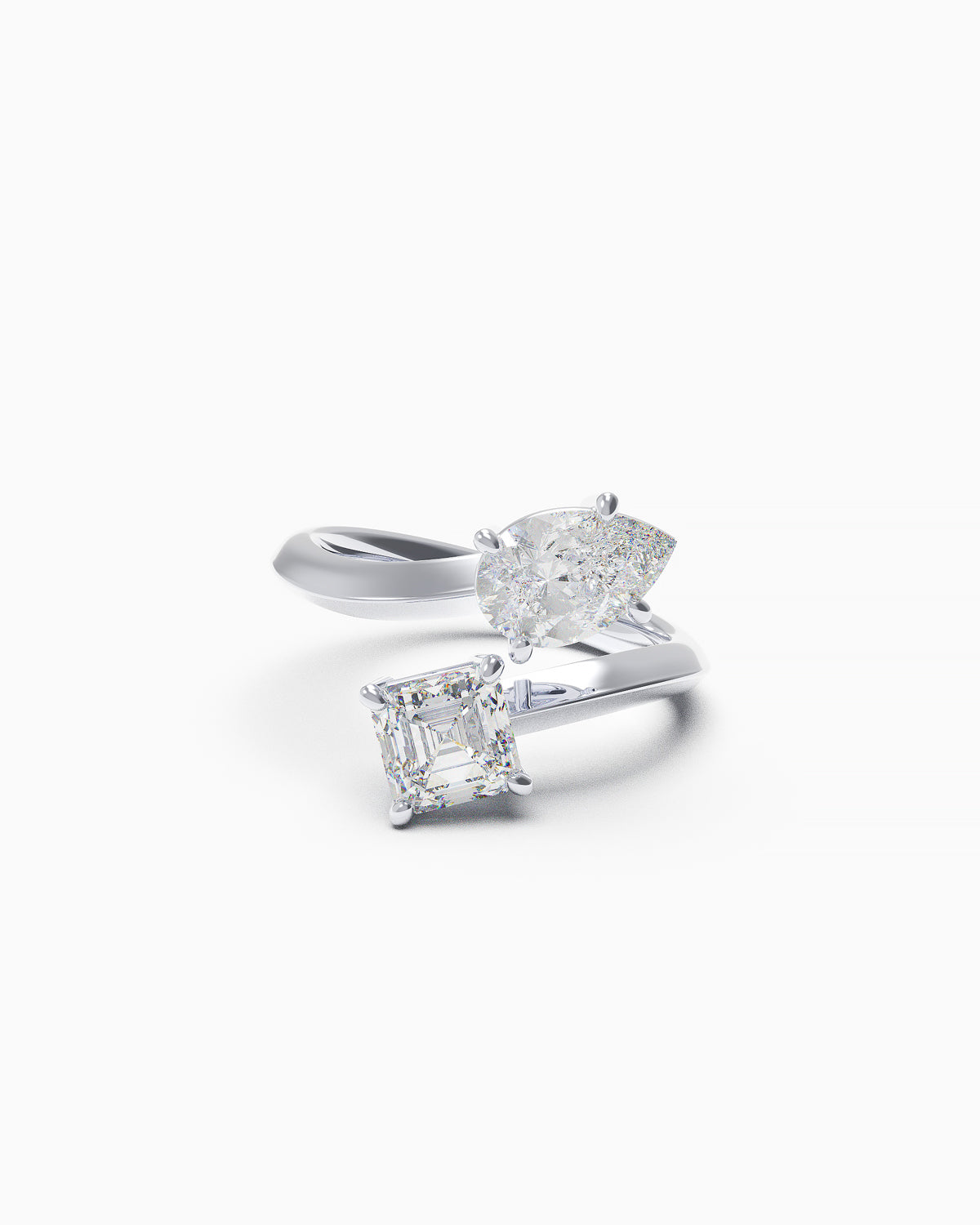 Toi et Moi bypass engagement ring in 18k white gold featuring pear and Asscher-cut diamonds in a wrap-around setting, front angle on white background.