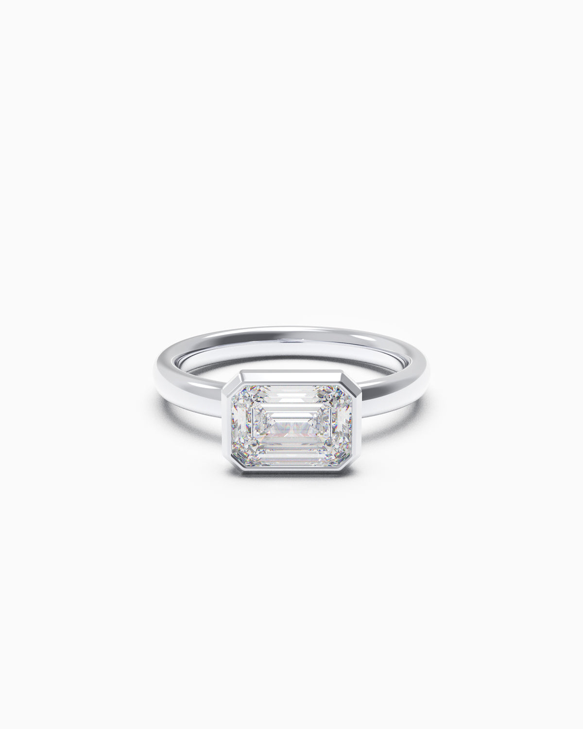 East-West Emerald Bezel Engagement Ring