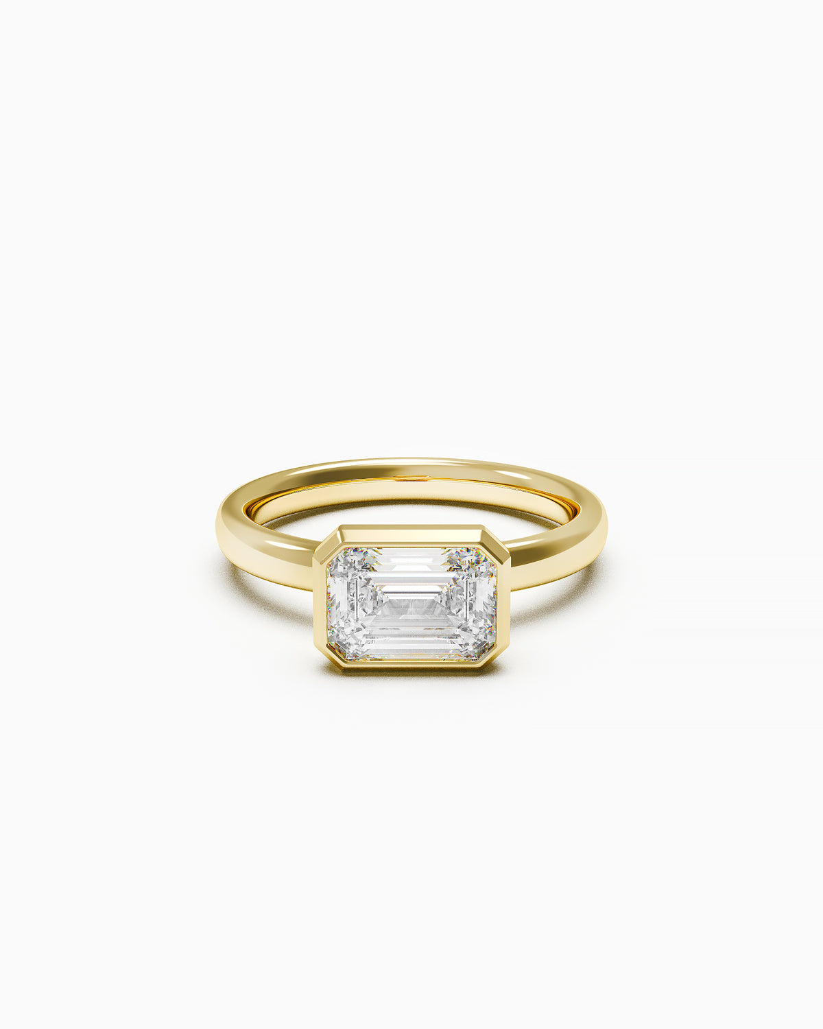 East-West Emerald Bezel Engagement Ring