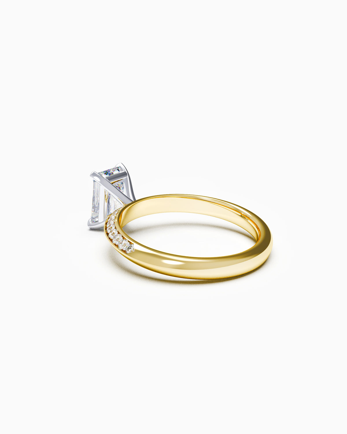 Side profile of an emerald-cut diamond ring featuring a pavé knife-edge band, showing the taper and height of the claw setting.