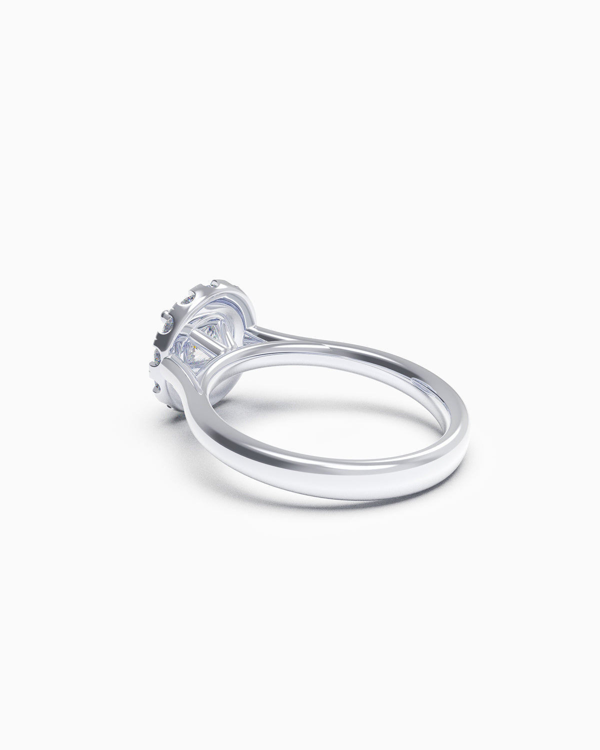 Side view of a round halo diamond ring with a slim polished band and raised claw-set centre stone, available in all 18k gold colours.