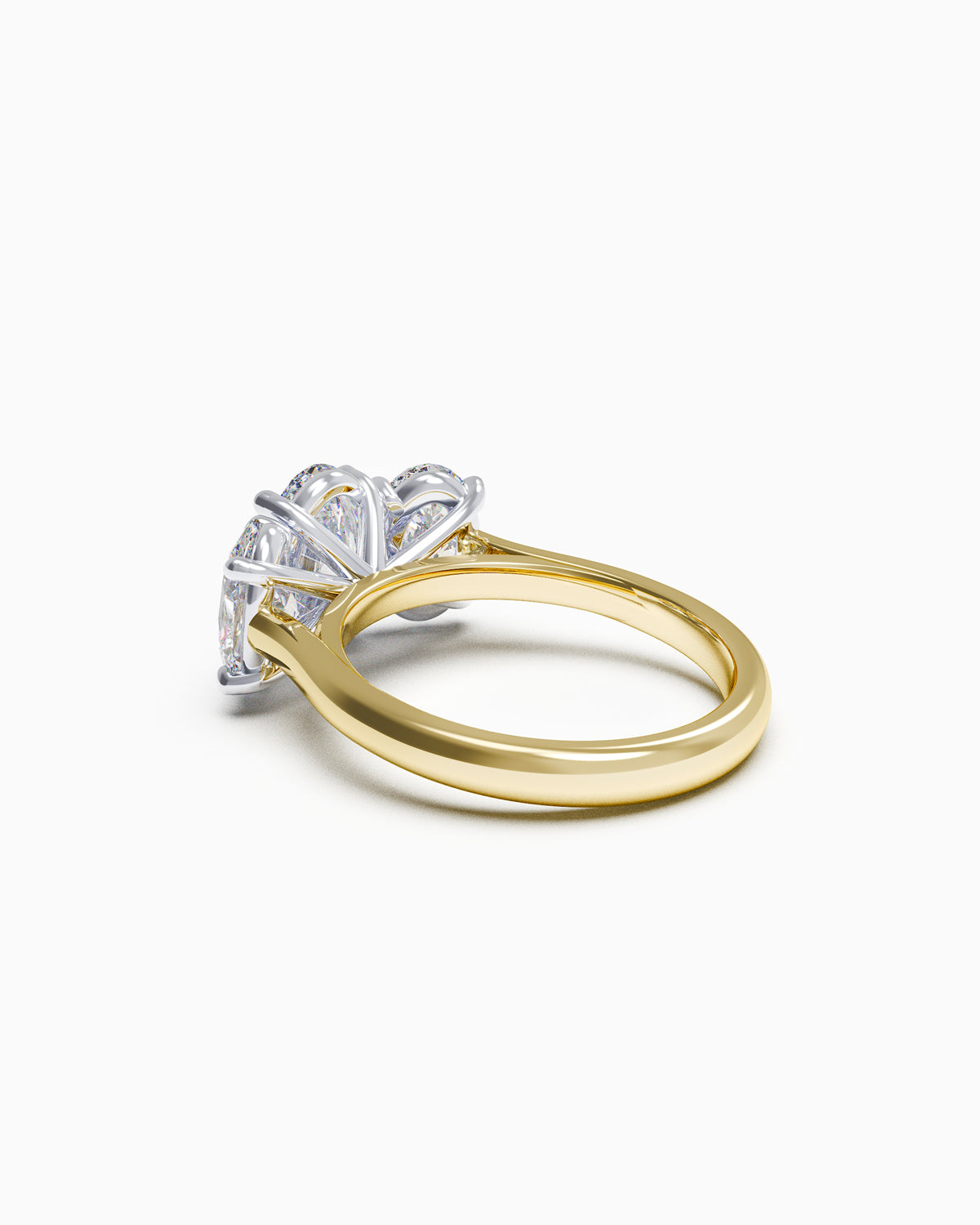 Side view of an oval trilogy diamond ring with claw settings, highlighting the low-profile design and customisable 18k gold band.
