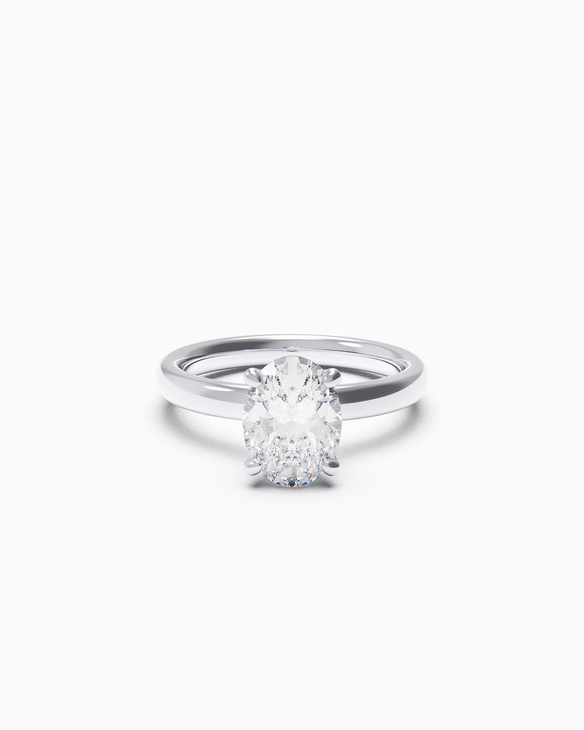 An engagement ring featuring an oval-cut diamond in a double claw setting, available in yellow or white gold, photographed on a white background.