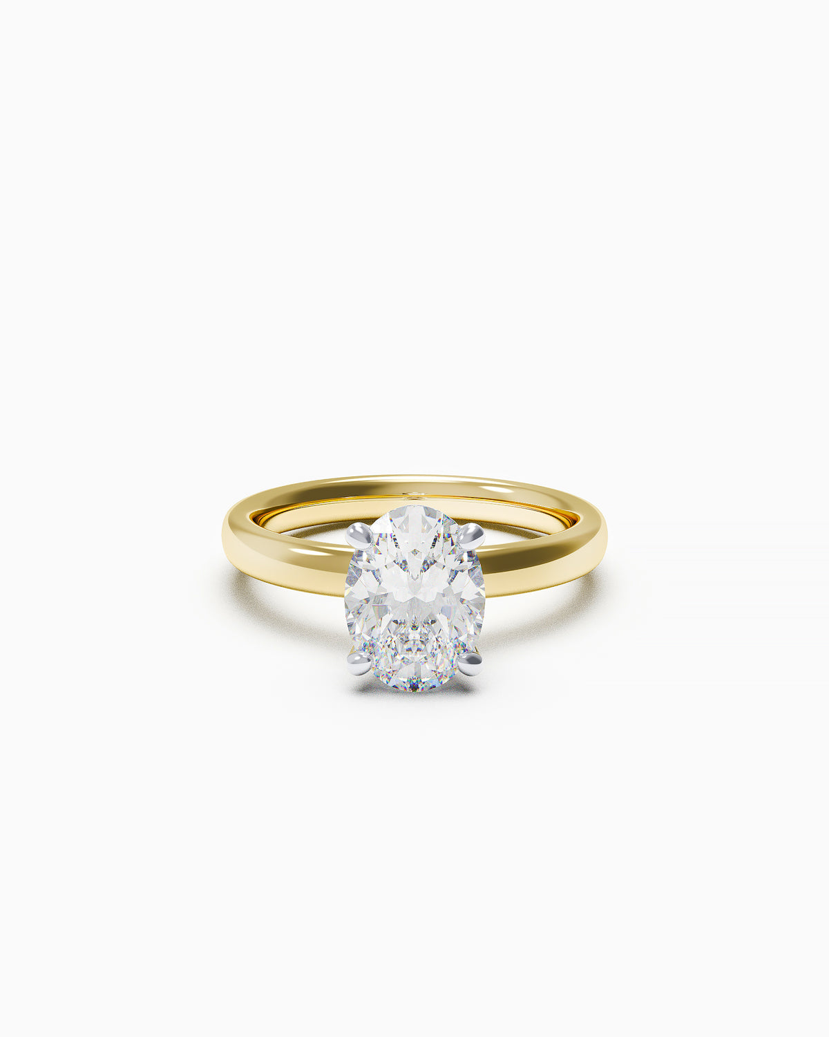 An engagement ring featuring an oval-cut diamond in a double claw setting, available in yellow or white gold, photographed on a white background.