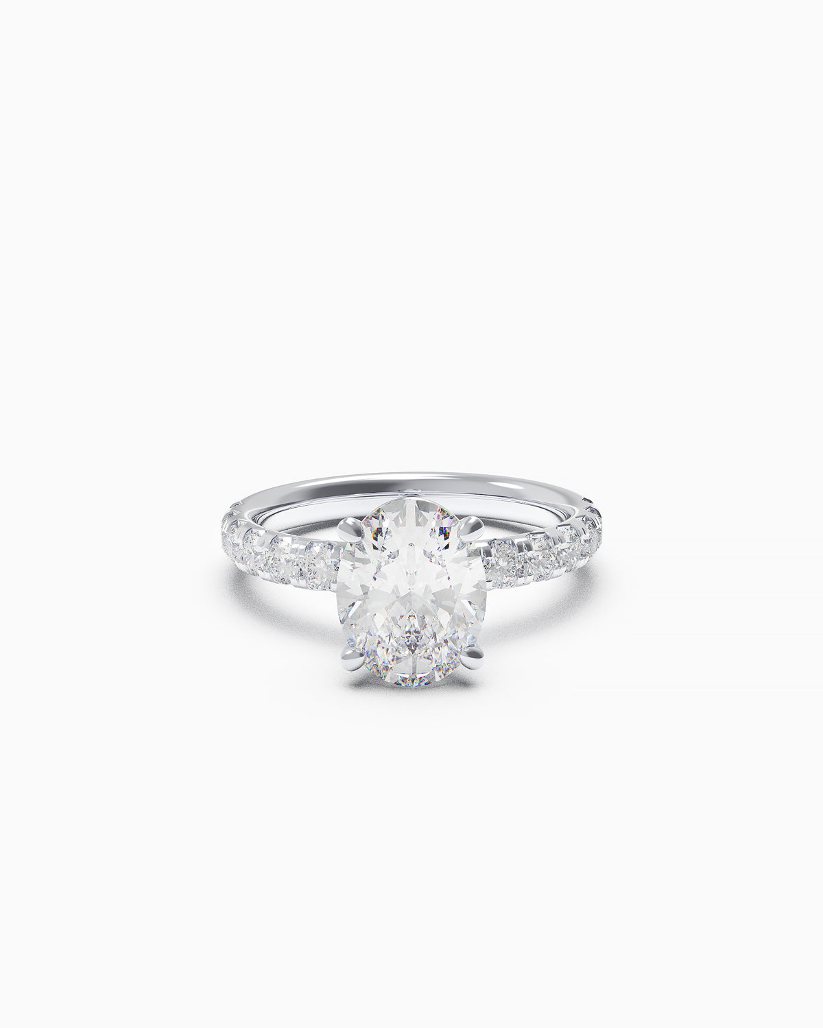Oval-cut diamond engagement ring with a French-set diamond band in white or yellow gold, front view on white background.