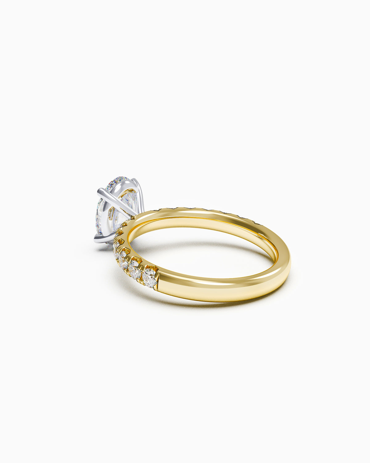 Side profile of an oval-cut diamond ring with a French-set band, showing the elevated setting and diamond detailing along the shoulders.