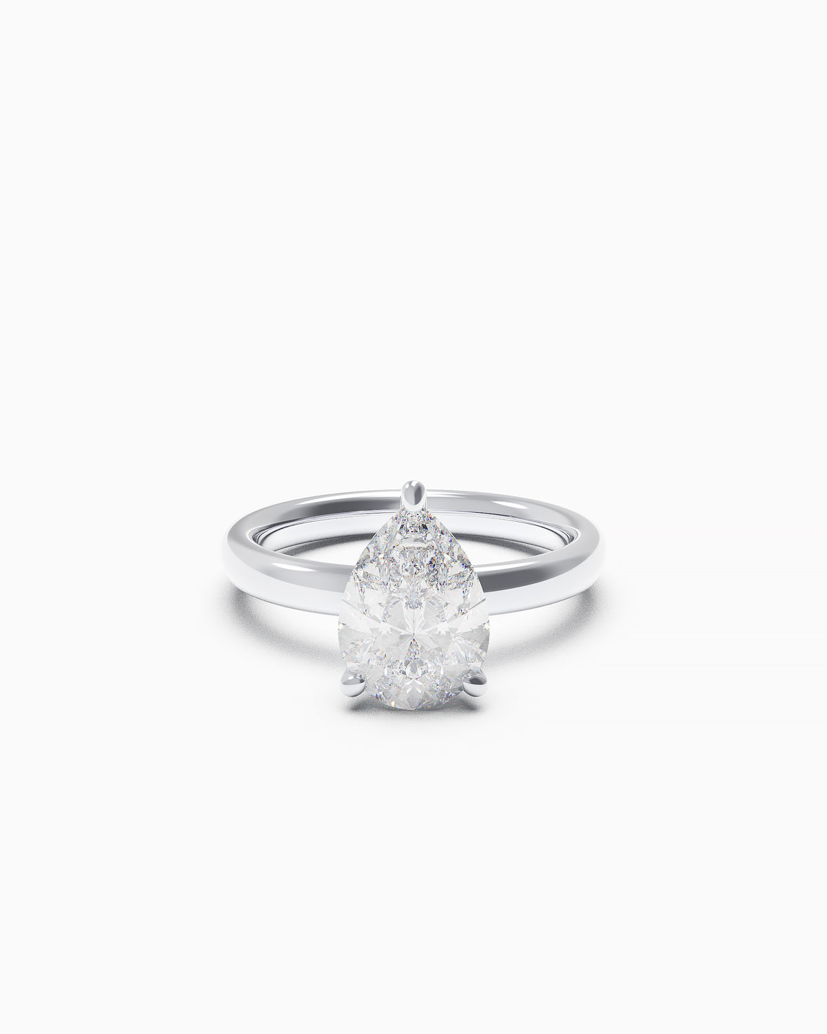 Pear-shaped diamond solitaire ring in a three-claw setting, available in yellow or white gold, front view on white background.