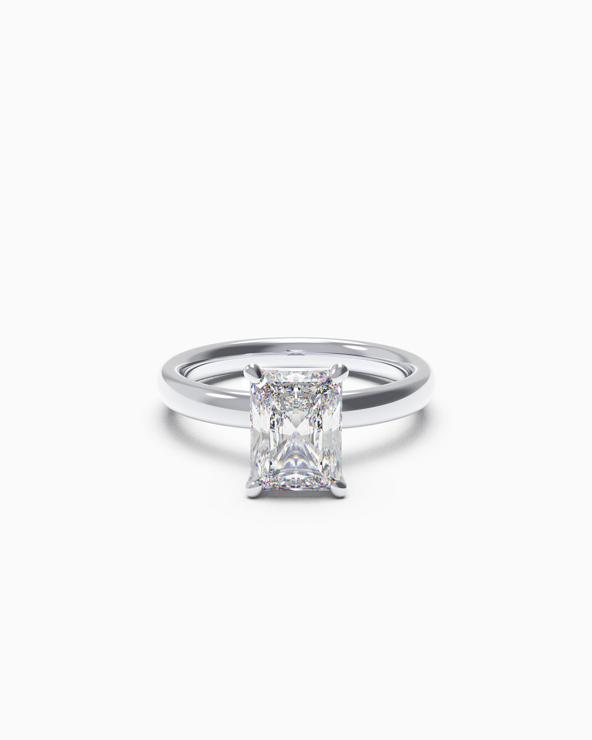 A radiant-cut diamond solitaire engagement ring in a four-claw setting, available in yellow or white gold, photographed on a white background.