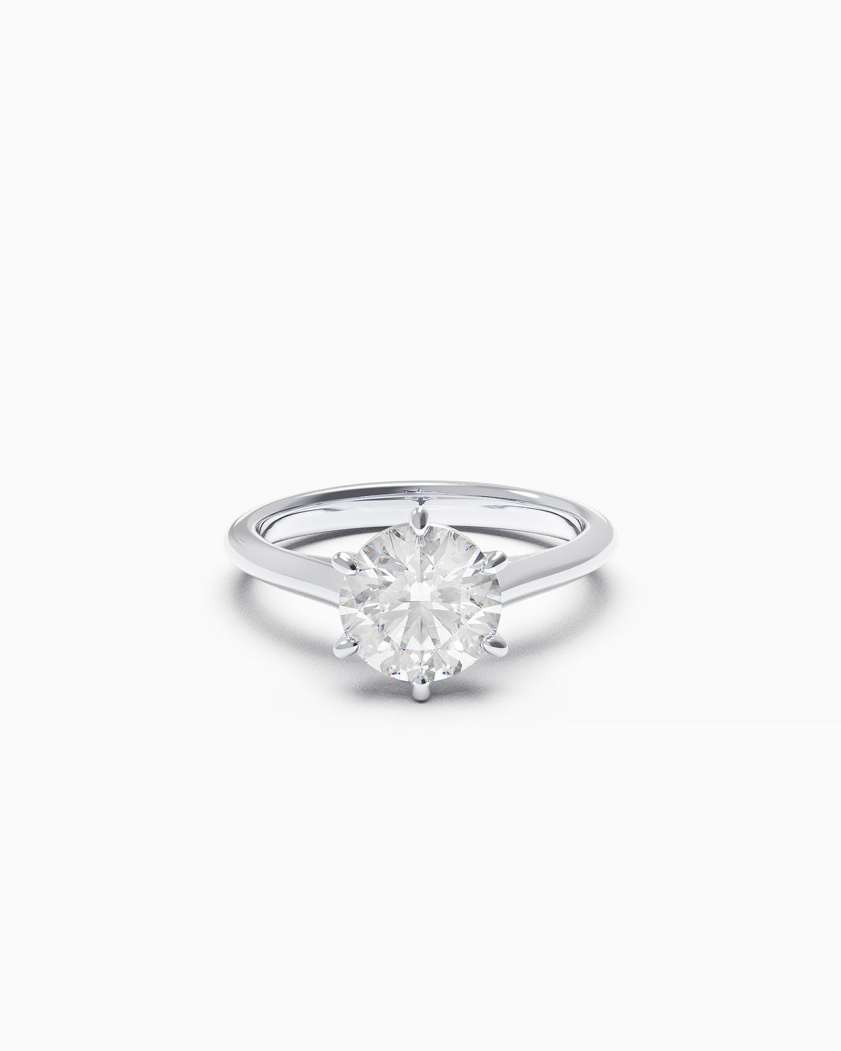 Round brilliant-cut diamond solitaire ring with six claws and cathedral shoulders, available in white or yellow gold, front view on a white background.