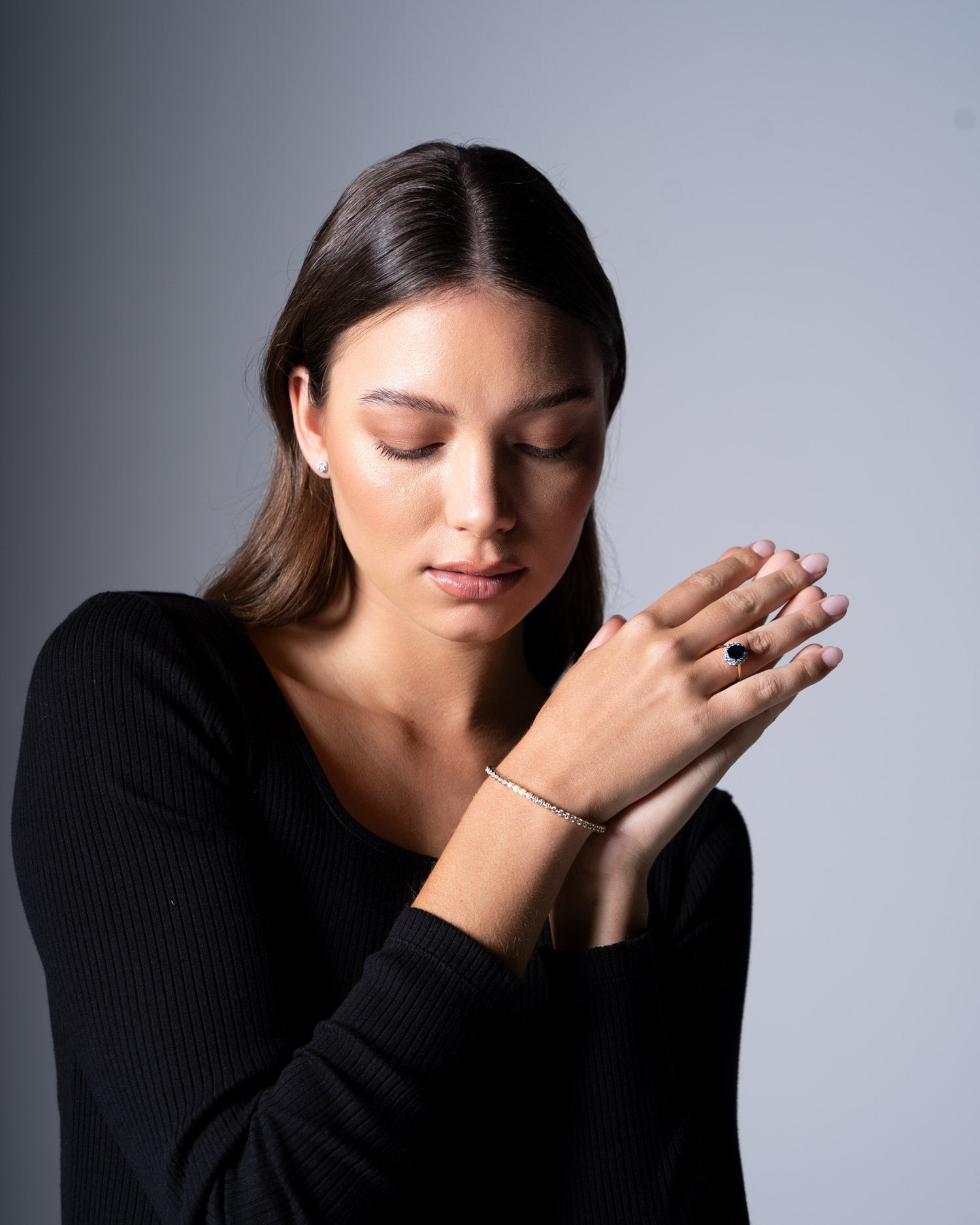 diamond bezel set flexible bangle and diana sapphire ring worn by model Ellie Brinkman.