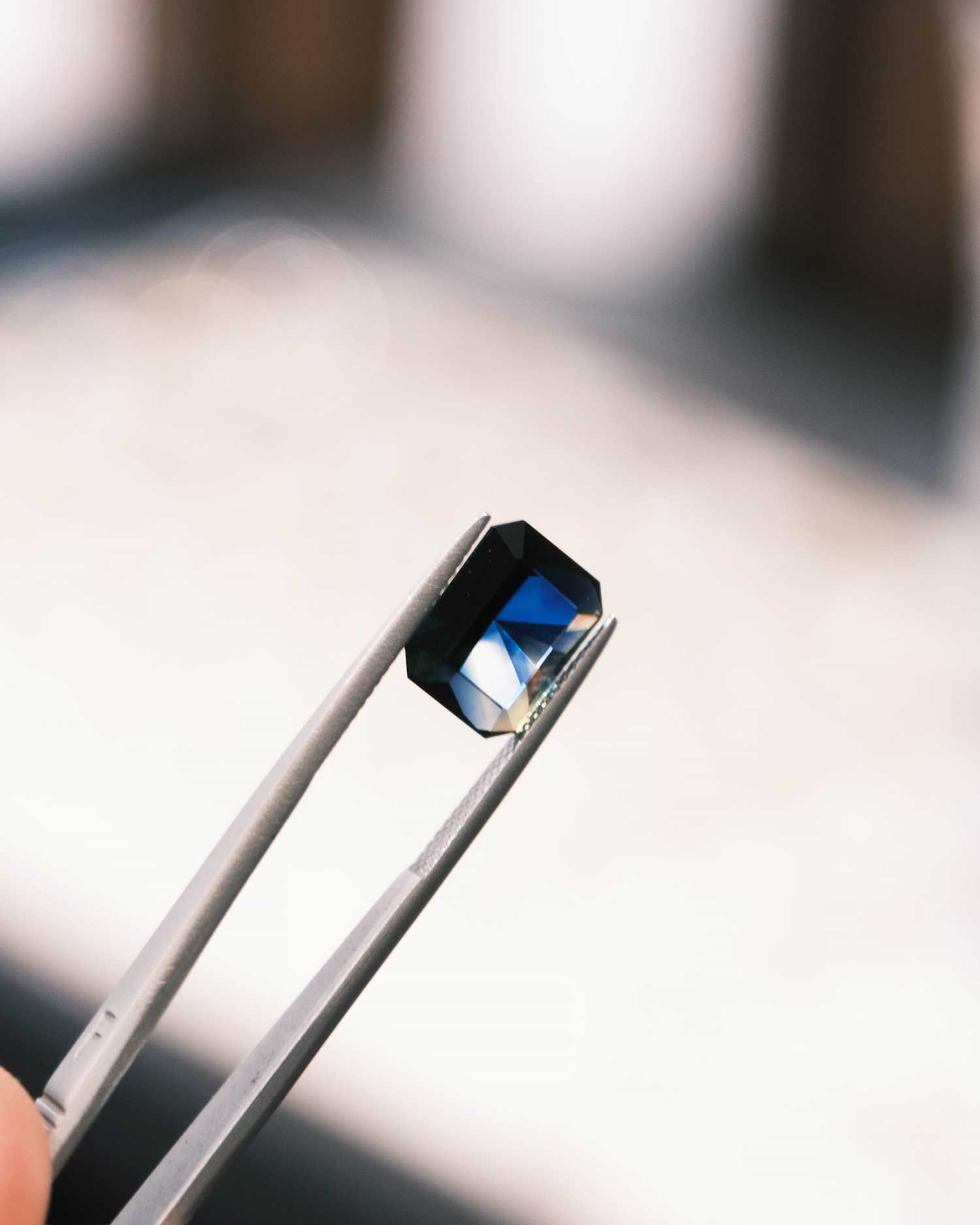 sapphire in between jewellers tweezers