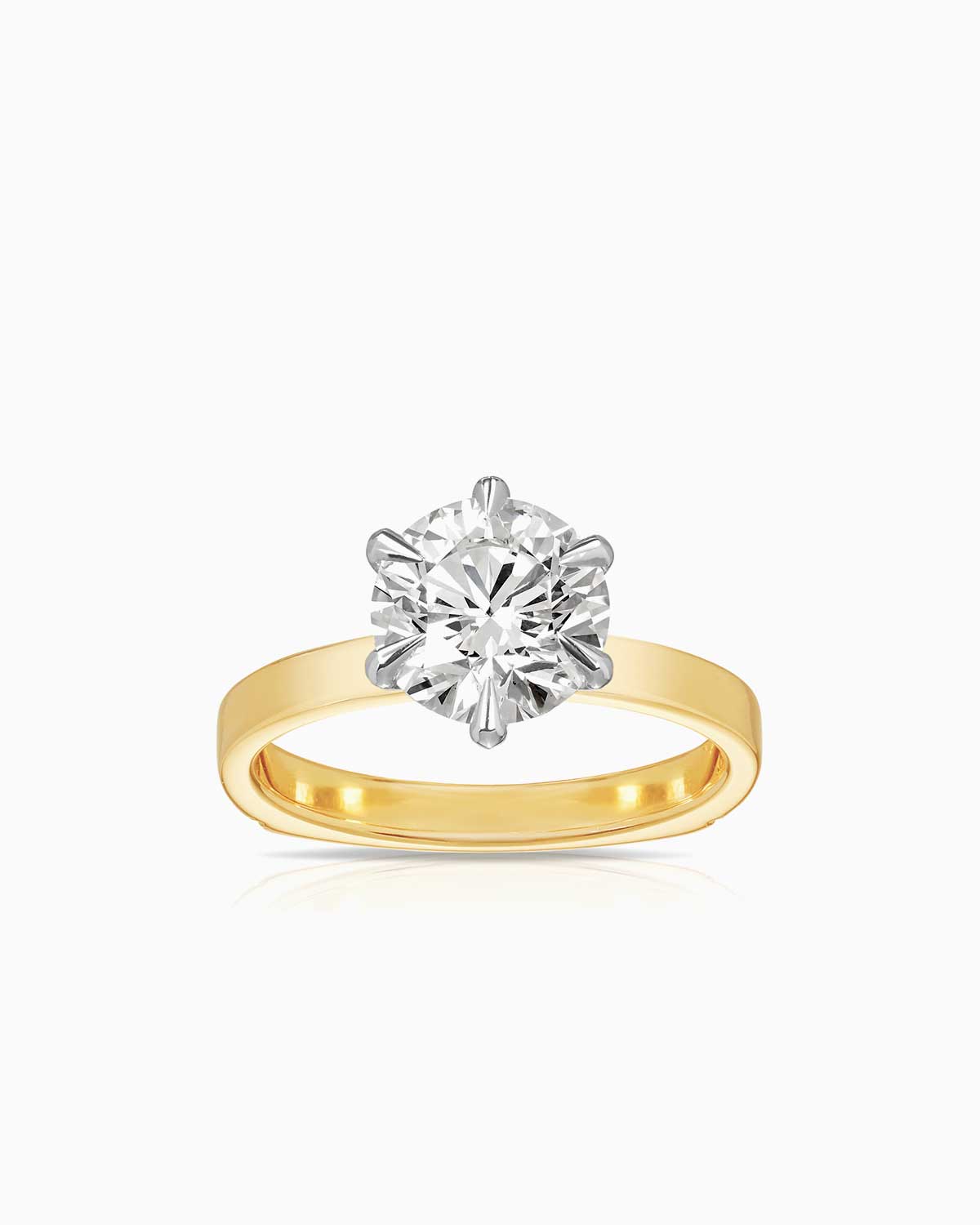 6 claw diamond solitaire engagement ring in 18 karat yellow gold by claude and me jewellery