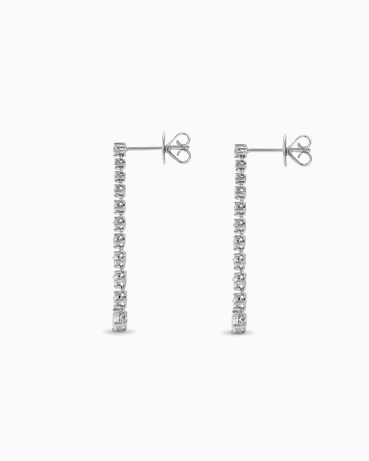 Side view of 18 karat white gold Lila drop diamond earring by claude and me jewellery