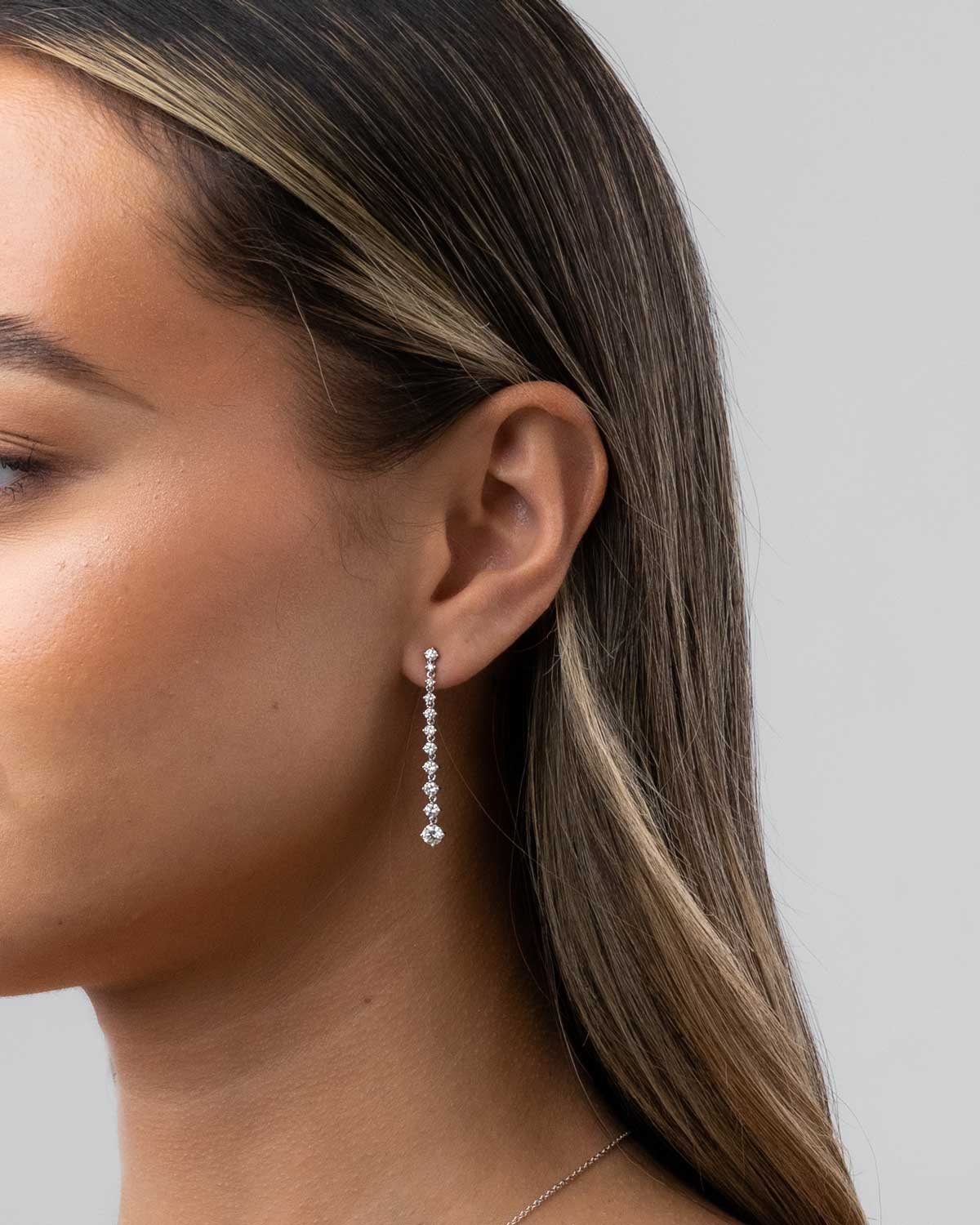 Model imagery of 18 karat white gold Lila drop diamond earring by claude and me jewellery