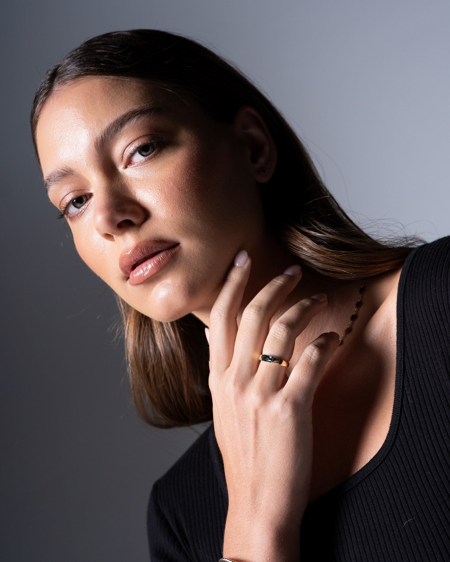 close up image of tension set australian sapphire ring worn by model Ellie Brinkman