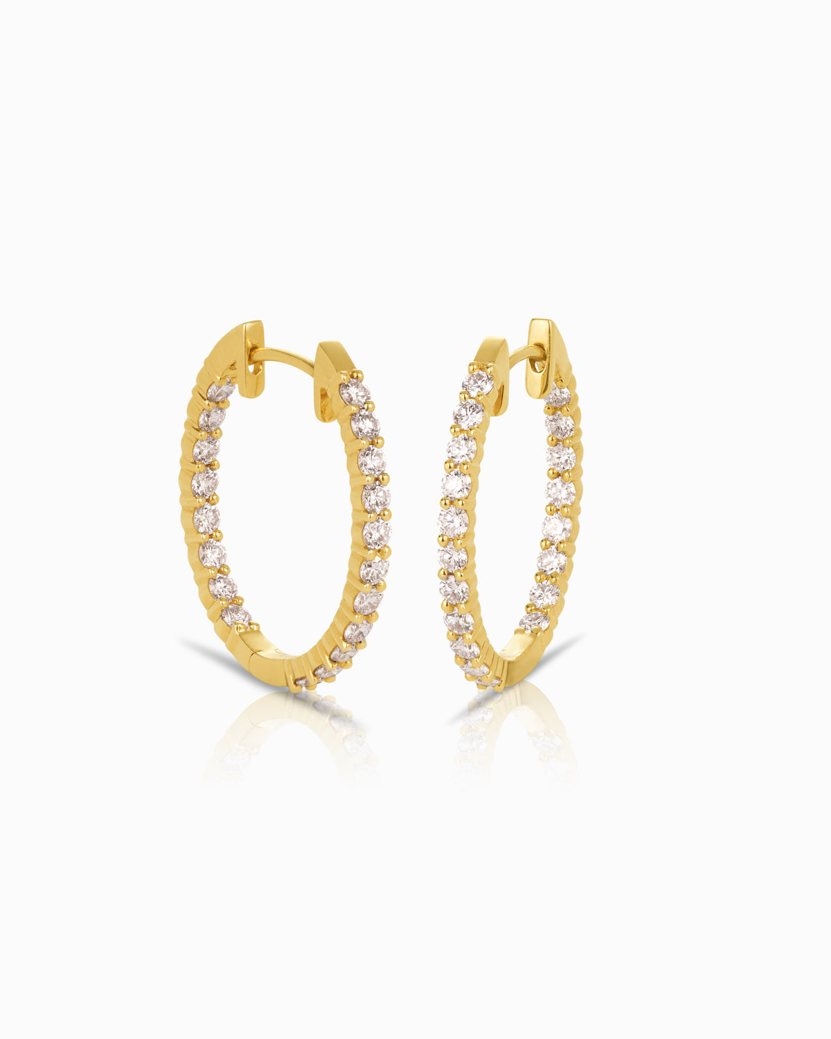 18k yellow gold oval hoop earrings with 1.11ct FG/SI diamonds in a classic shared prong setting.