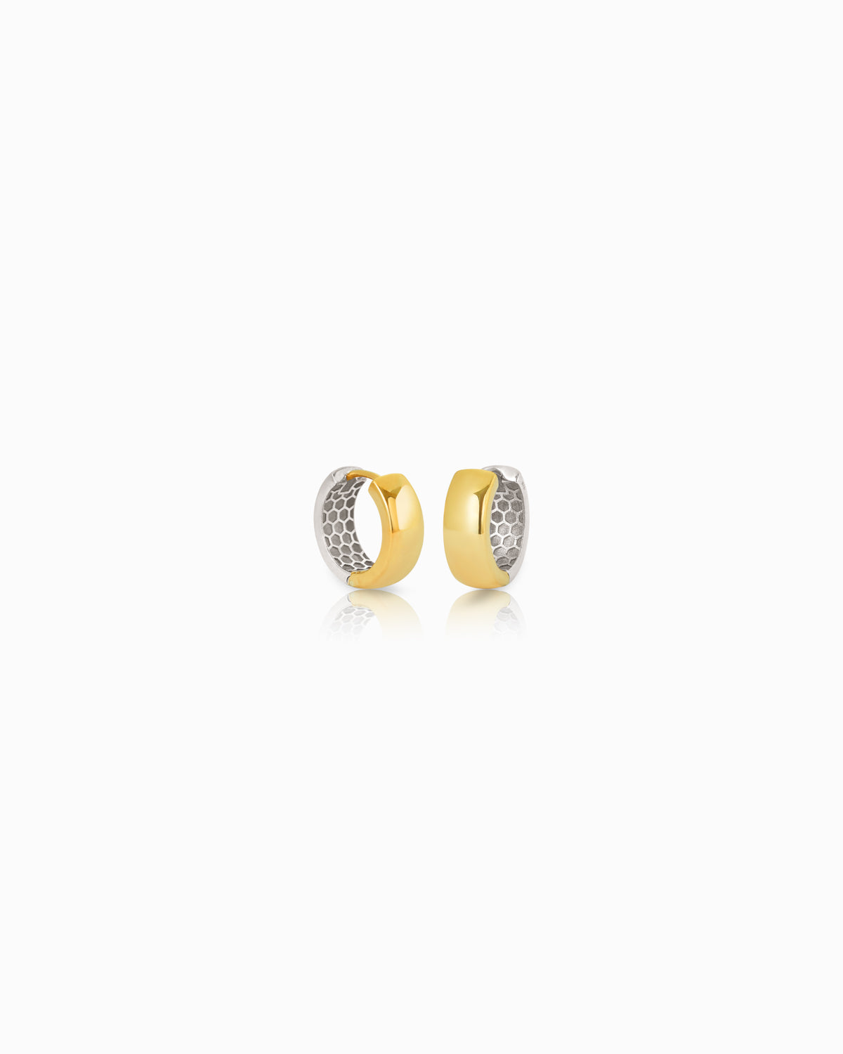 Two gold hoop earrings with textured design on a white background