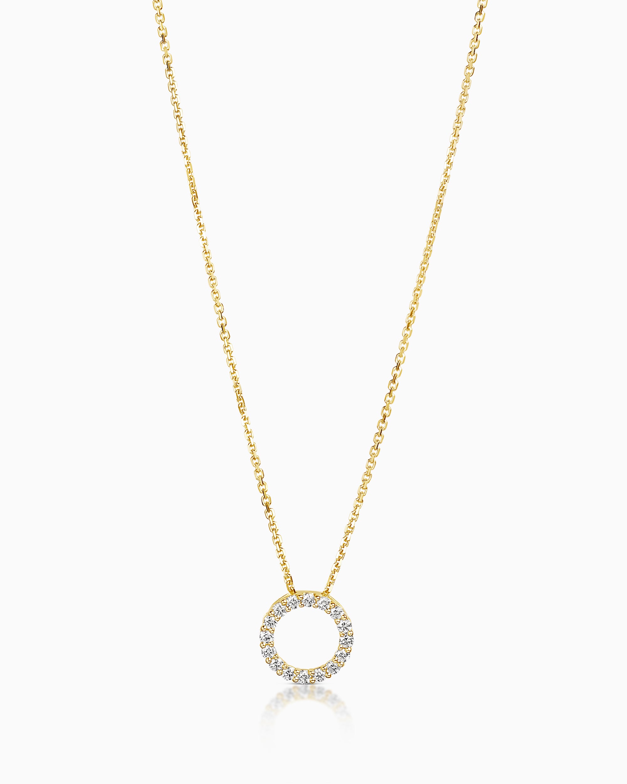 Gold necklace with a circular pendant on a white background