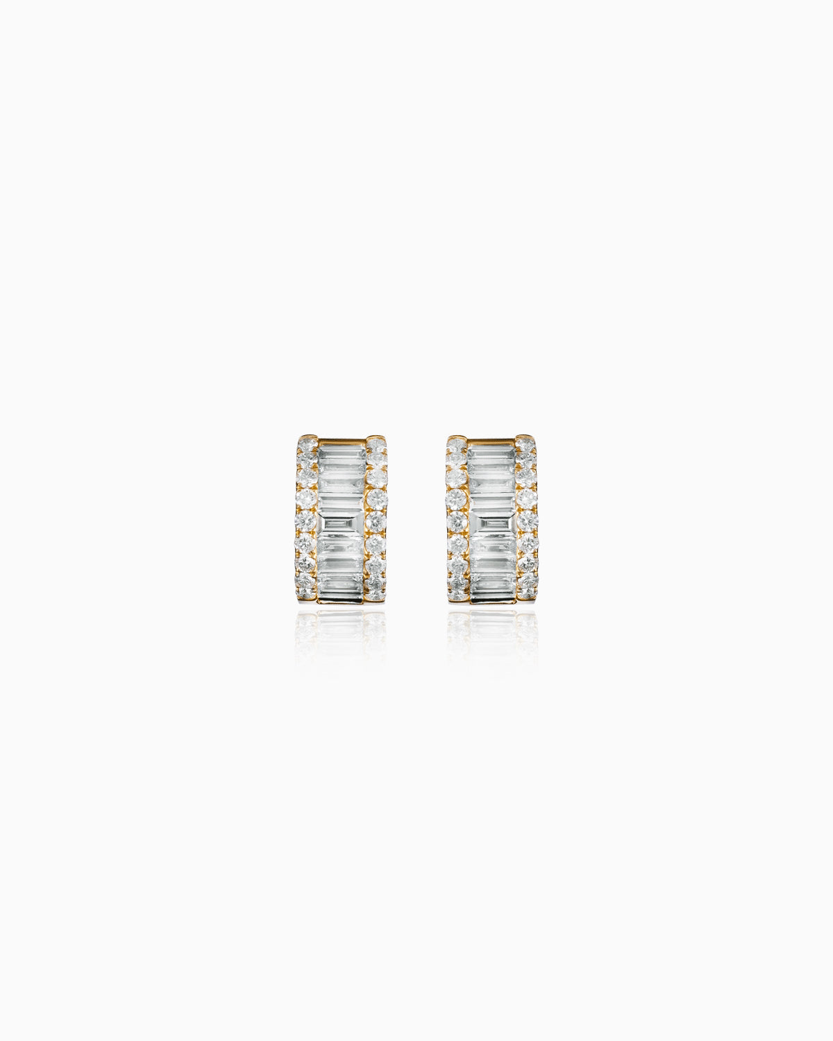 A pair of earrings featuring 1.24 carats of diamonds, with sleek baguette-cut diamonds at the center framed by a sparkling row of round brilliant diamonds. The stones are set in radiant 18k gold, creating a striking blend of modern design and classic elegance. The earrings are displayed in a front-facing view, highlighting their intricate detailing and dazzling shine.