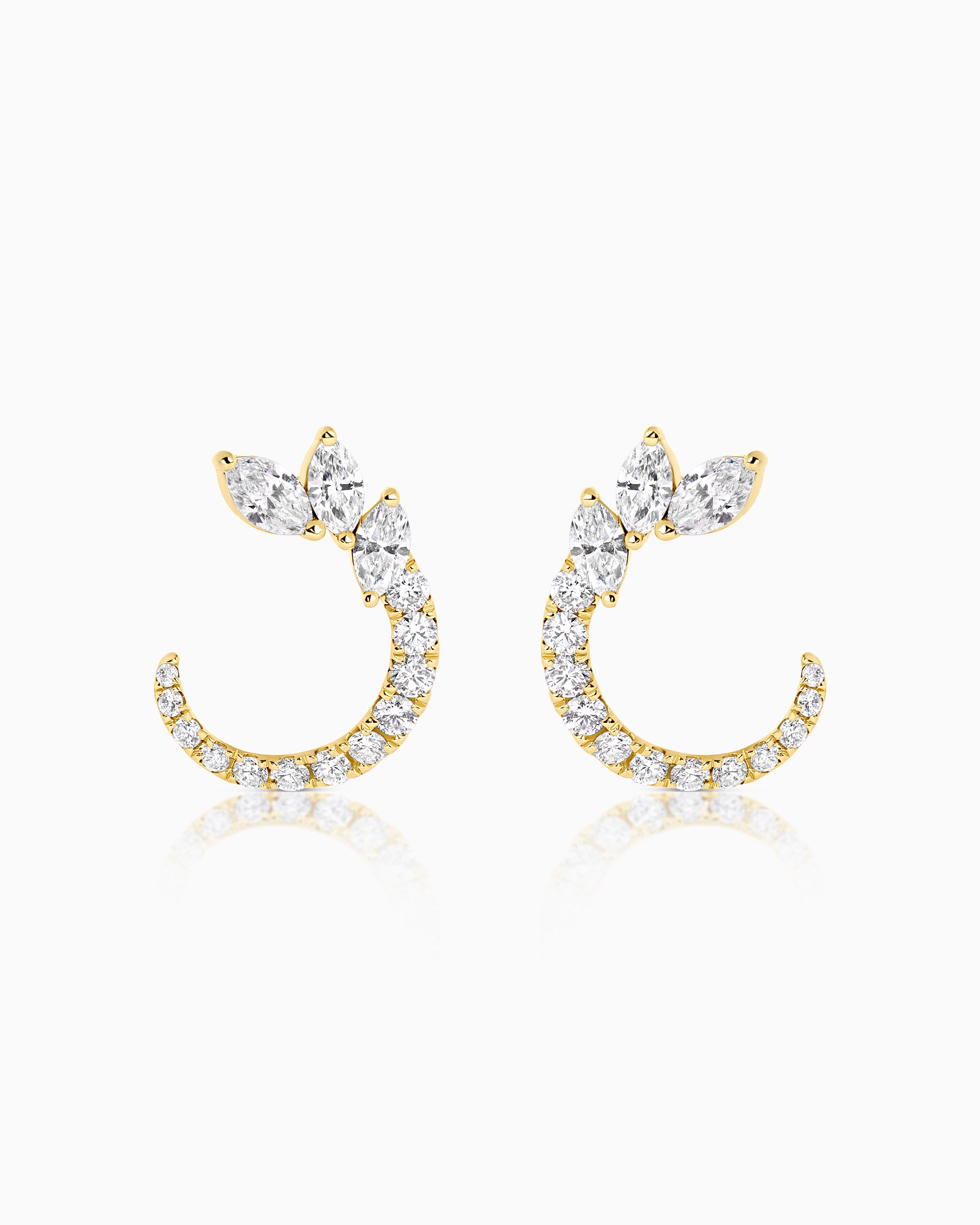 Pair of 18k yellow gold diamond crescent earrings with a fan of marquise-cut diamonds above a curved pavé-set arc of round brilliant diamonds, photographed on a white background