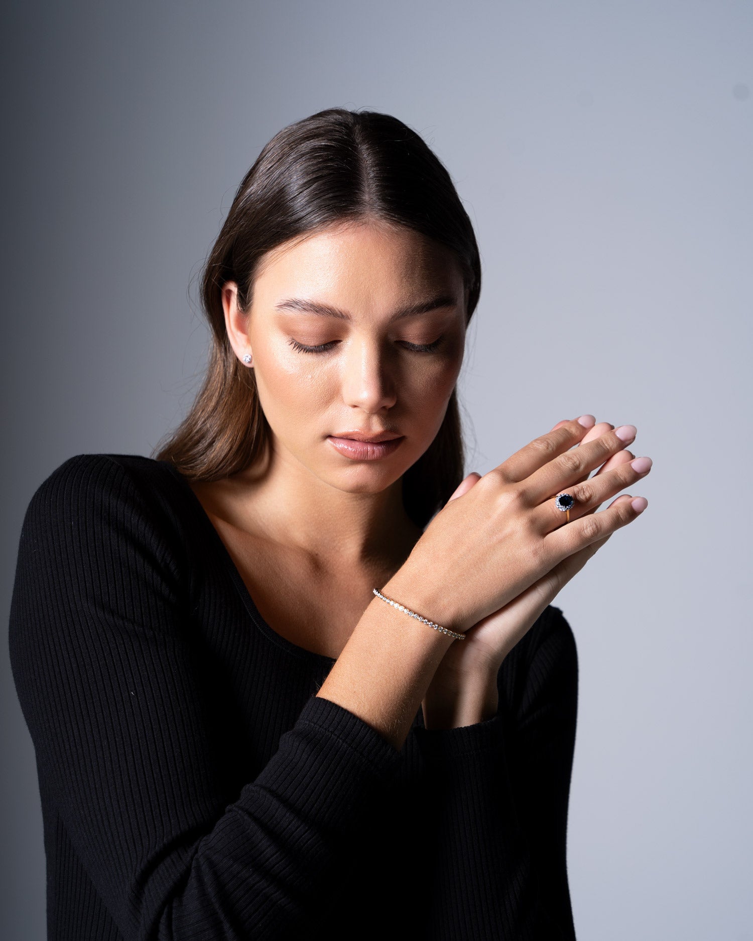 diamond bezel set flexible bangle and diana sapphire ring worn by model Ellie Brinkman.