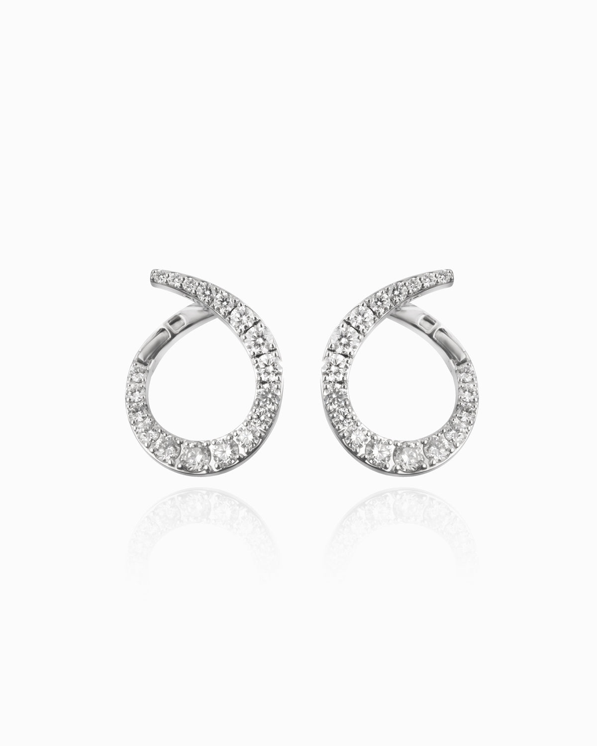 18kwg diamond swirl earrings on a white background