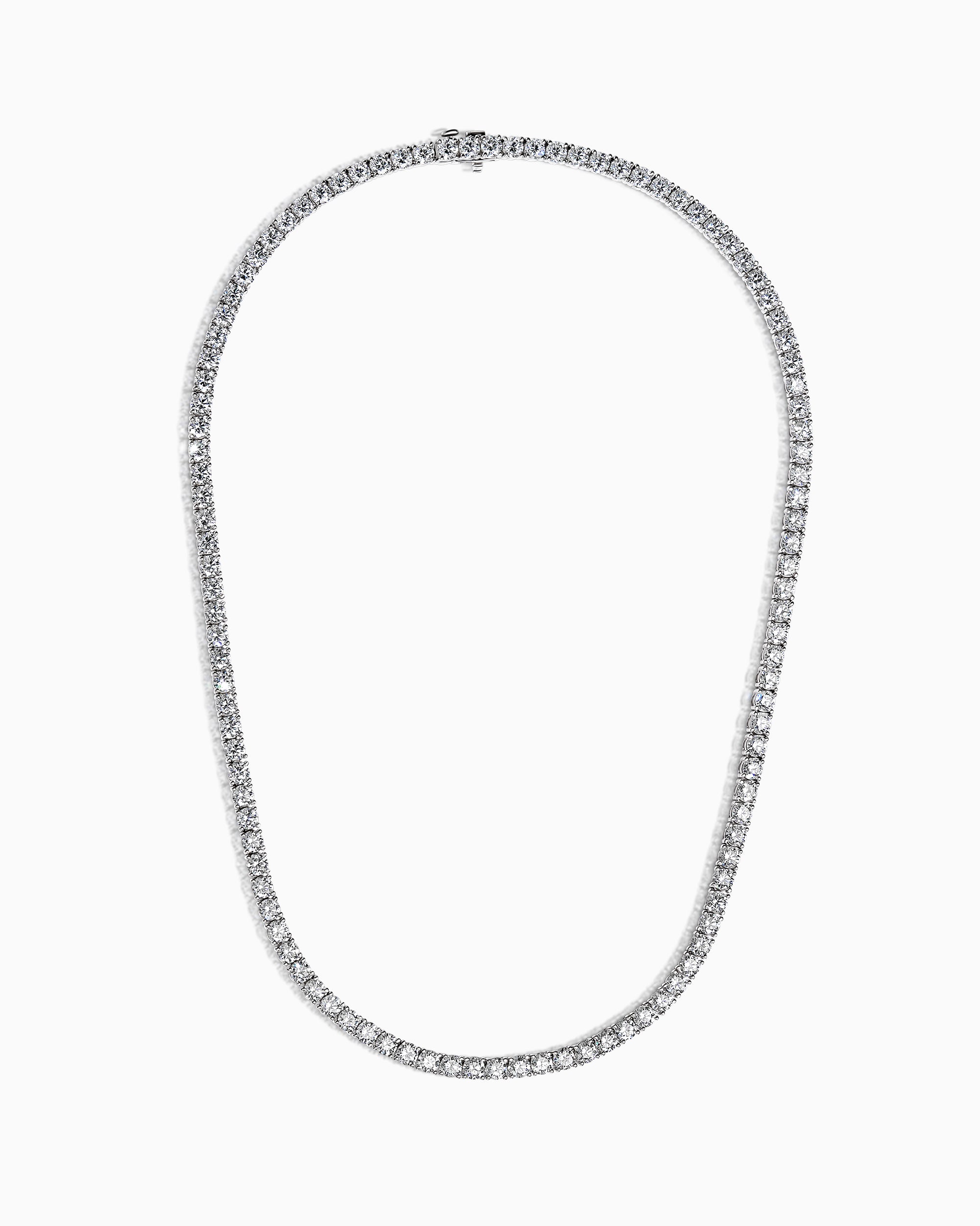 18k white gold diamond line necklace with 109 round brilliant diamonds in four-claw settings, photographed on white background.