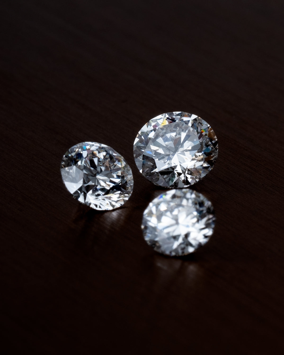 macro shot of three loose natural diamonds by claude and me jewellery