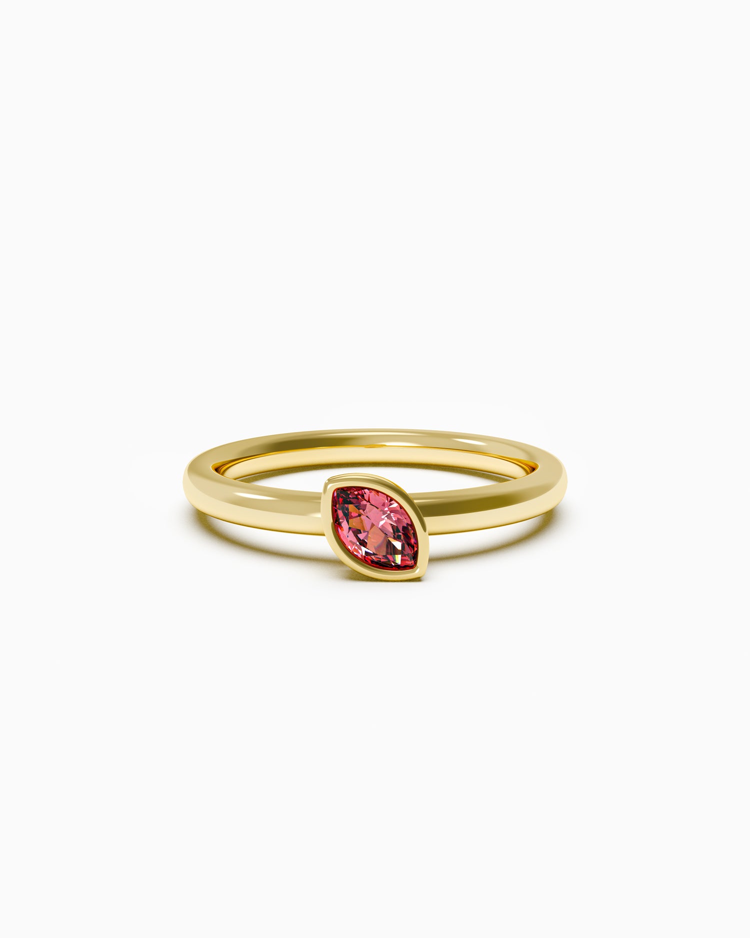 Gold ring with a red gemstone on a white background