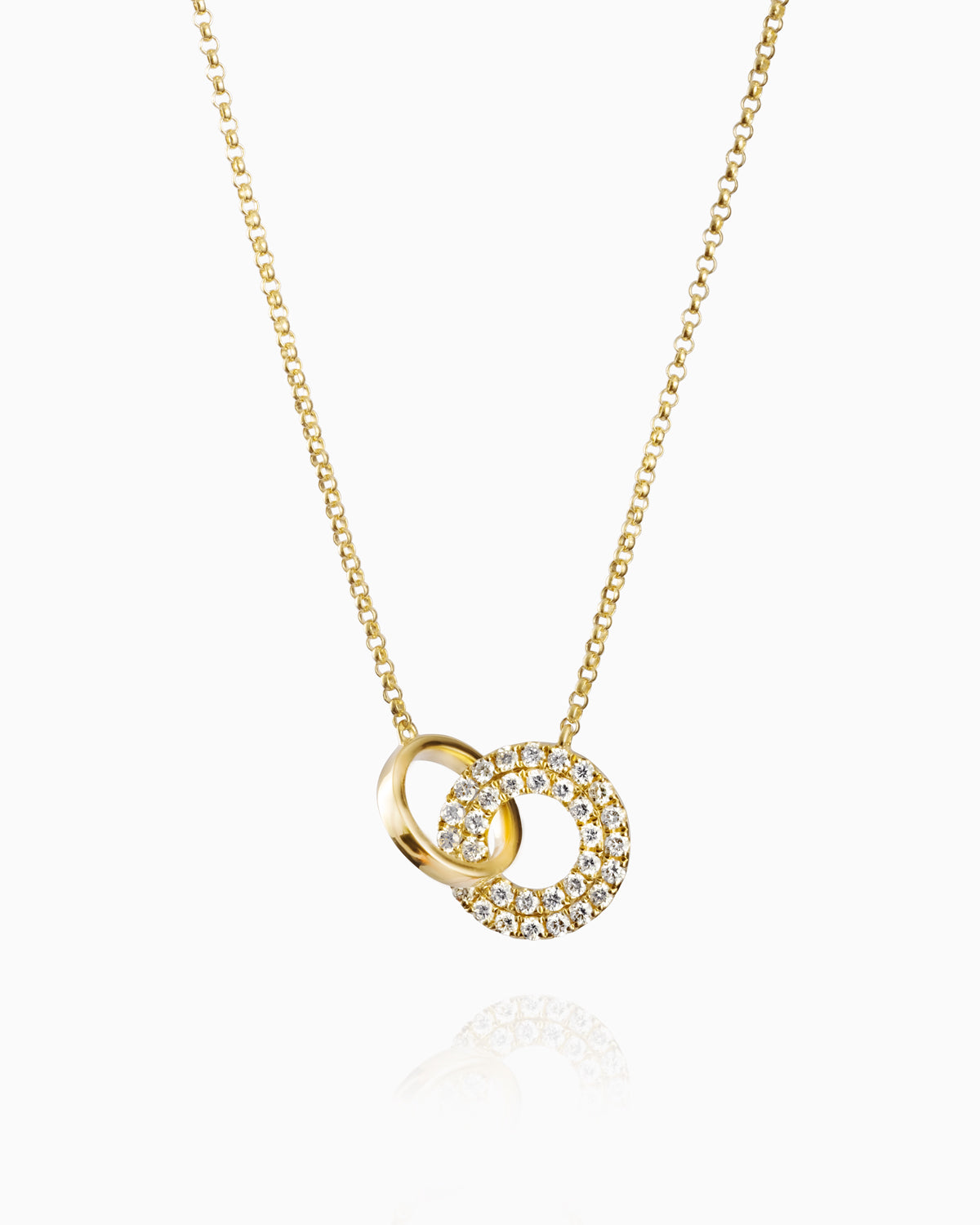 Elegant 18k yellow gold pendant featuring two intertwined circles, one polished and one adorned with pavé diamonds, reflecting luxury and unity.