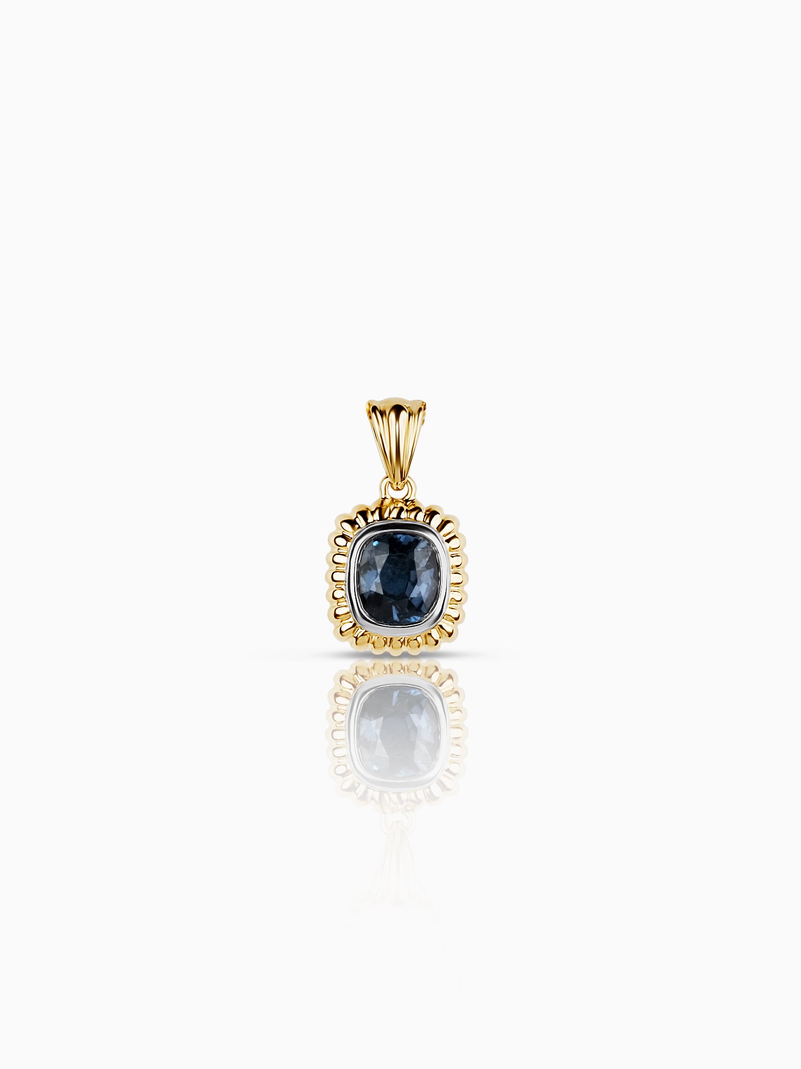 Yellow gold pendant with a cushion-cut blue-grey stone in a white gold bezel surrounded by a beaded scalloped gold border, photographed against a white background.