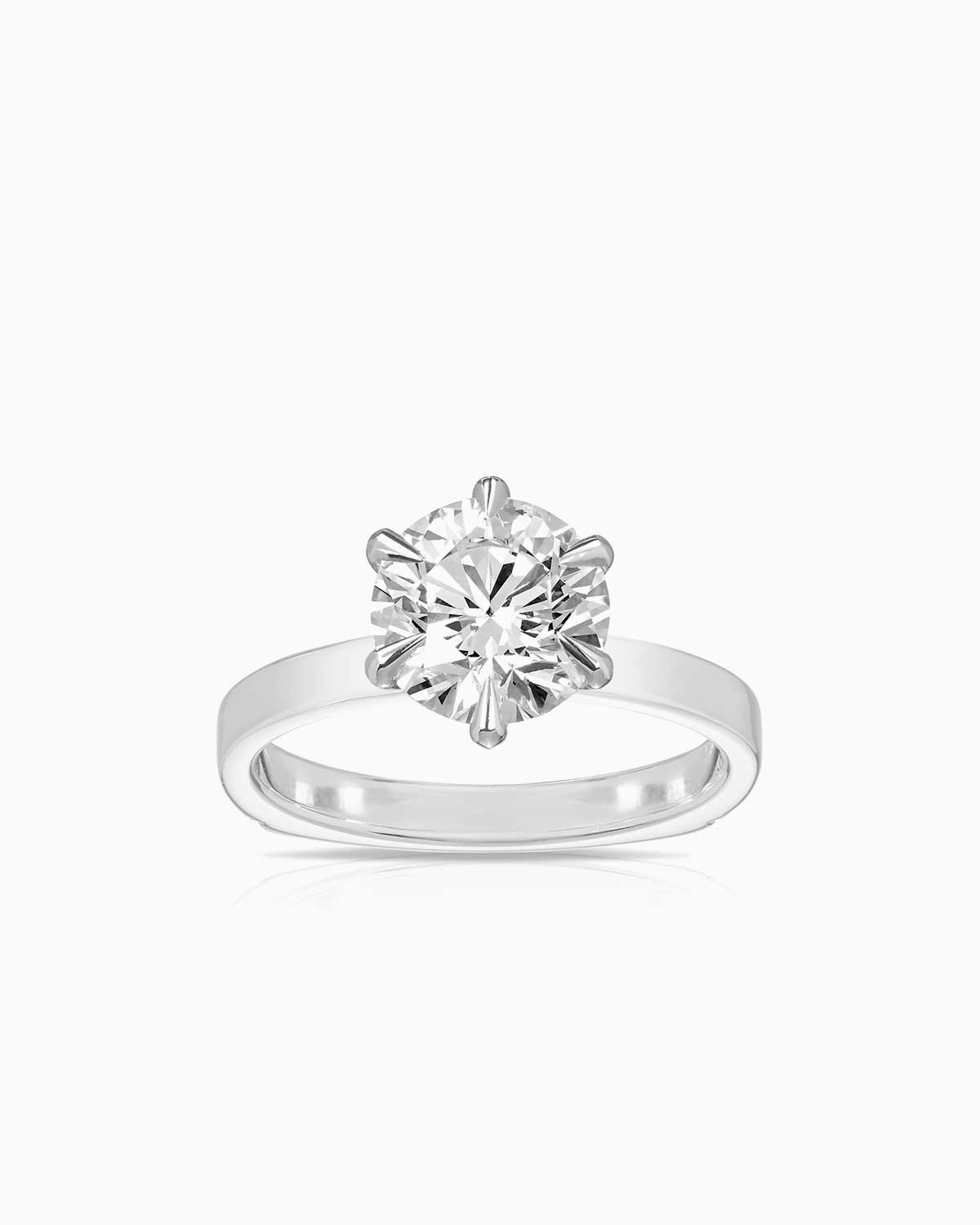 6 claw diamond solitaire engagement ring in 18 karat white gold by claude and me jewellery
