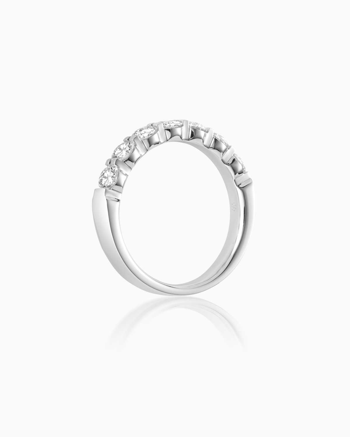 7 stone quintessential diamond wedding band in 18 karat white gold by claude and me jewellery.