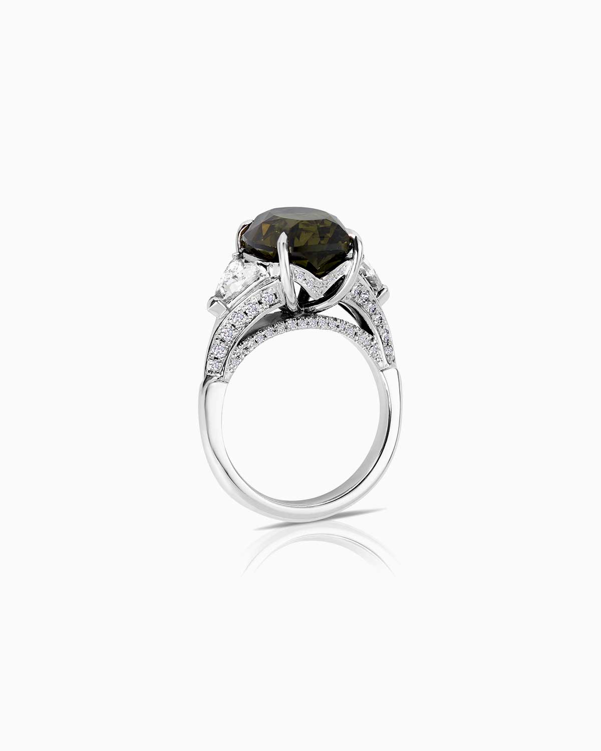 8.08ct Australian green sapphire trilogy featuring GIA certified triangle cut diamonds and set in 18 karat white gold by claude and me jewellery.