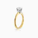 Side view of Round 6 claw basket solitaire engagement ring featuring 18 karat yellow and white gold by claude and me jewellery.