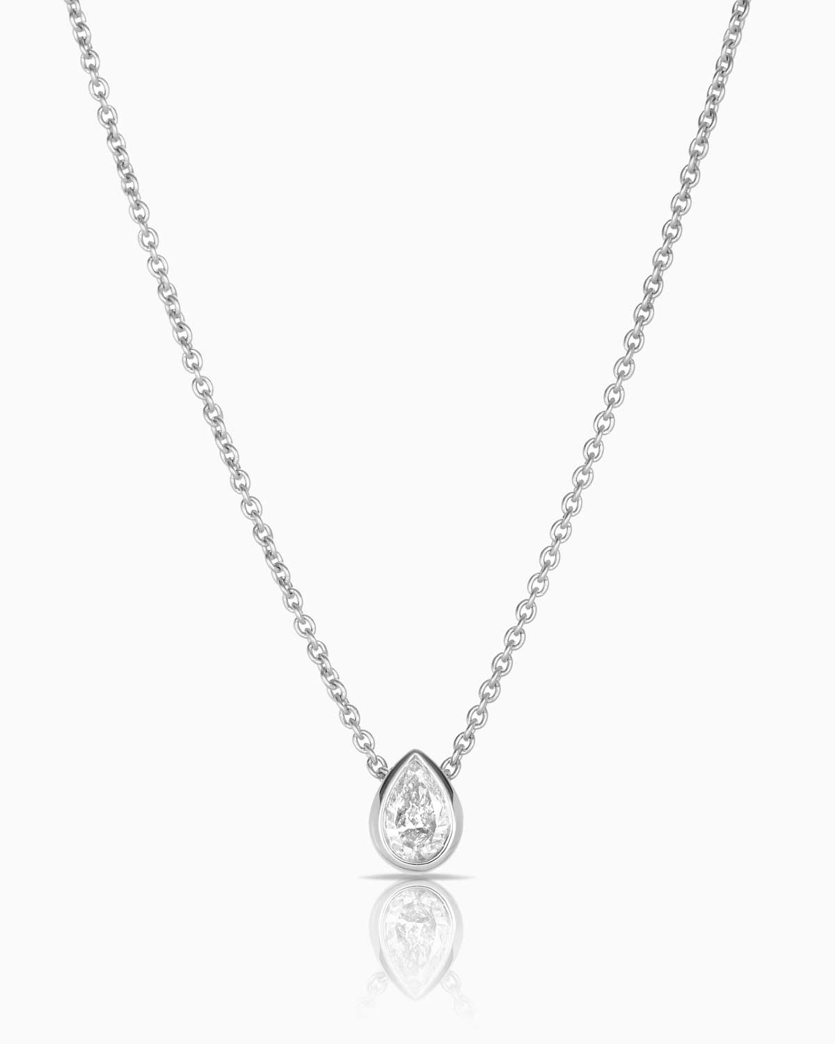 pear diamond necklace featuring a 0.27ct pear cut diamond bezel set in 9 karat white gold along a delicate cable link chain.