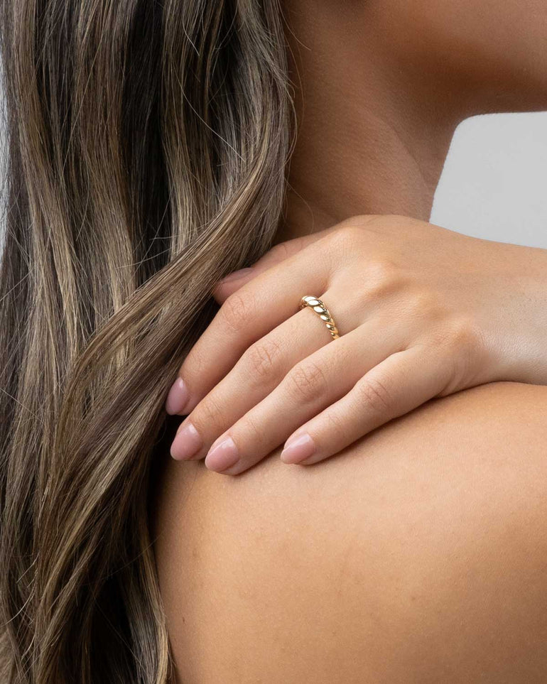 Model imagery over shoulder of the Mini 10 karat yellow or white gold croissant ring from claude and me jewellery
