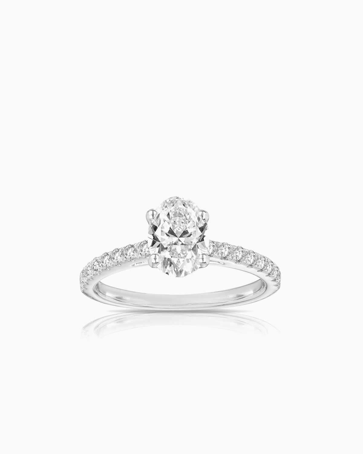 oval diamond engagement ring featuring shoulder diamonds and set in 18 karat white gold by claude and me jewellery
