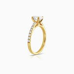 oval diamond engagement ring featuring shoulder diamonds and set in 18 karat yellow gold by claude and me jewellery