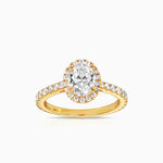 oval halo diamond engagement ring featuring shoulder diamonds and set in 18 karta yellow gold by claude and me jewellery.