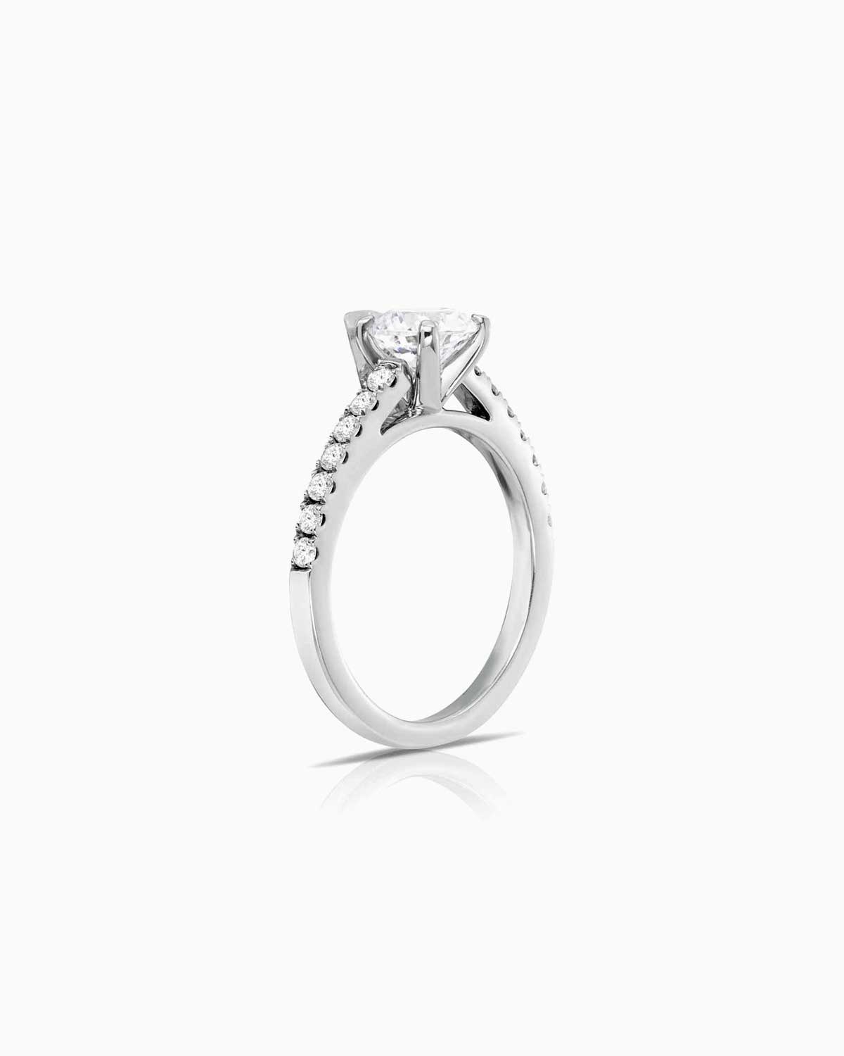 4 claw round diamond engagement ring with shoulder diamonds and set in 18 karat white gold by claude and me jewellery.