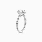 oval halo diamond engagement ring featuring shoulder diamonds and set in 18 karat white gold by claude and me jewellery