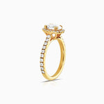 oval halo diamond engagement ring featuring shoulder diamonds and set in 18 karta yellow gold by claude and me jewellery.