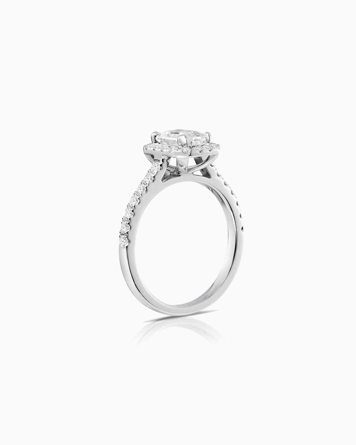 emerald cut halo diamond engagement ring set in 18 karat white gold by claude and me jewellery