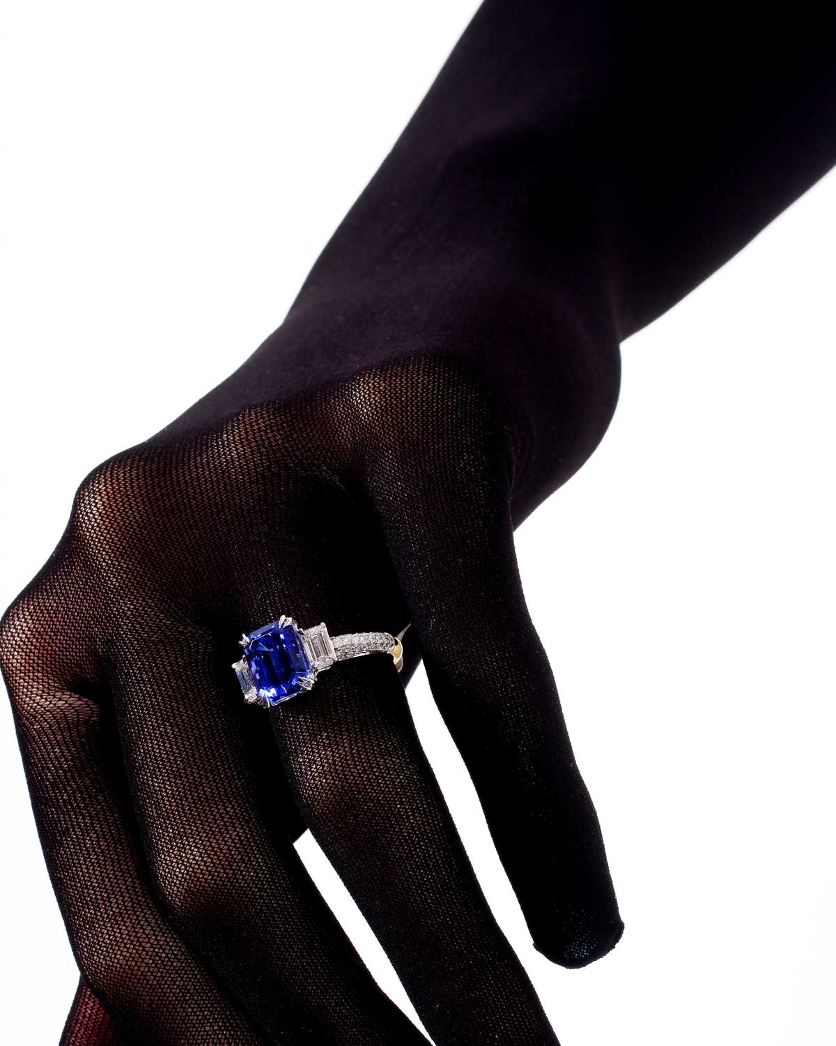 Model wearing 3.78ct tanzanite and diamond trilogy with pave set diamond shoulders and 18 karat white and yellow gold by claude and me jewellery.